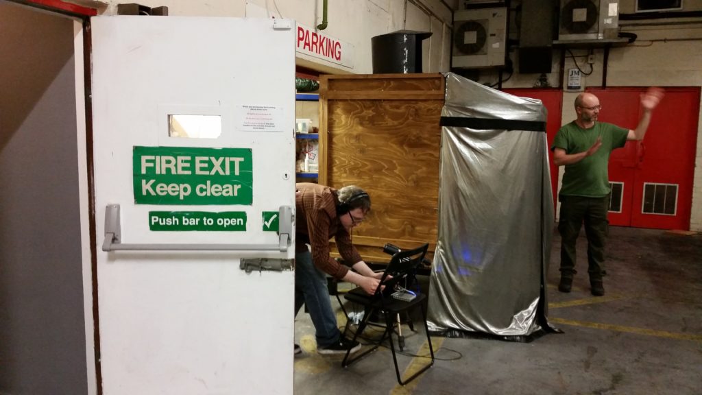 Michael Lightbourne and Pete Ashton doing technical rehearsals in the loading bay of Birmingham Open Media on a rainy day. 