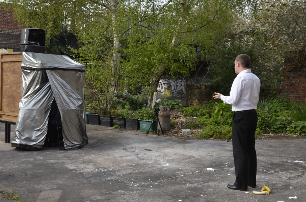 Matthew Tweedale performing to an audience inside the camera obscura.